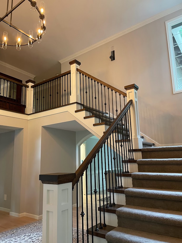 Brown wooden staircase with white trim in a home in Seattle, WA