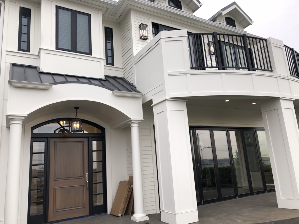 94C2C4AC-3BD5-4168-AFA8-387712F0C2D0 Brown front door from the exterior of a white painted house in Seattle, WA