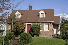 Q1 brick photo 1 A light brown brick house with a red door in Seattle, WA