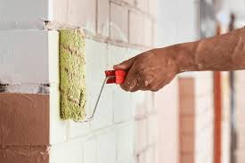 Q1 brick photo 4 A painter painting a white brick wall in Seattle, WA